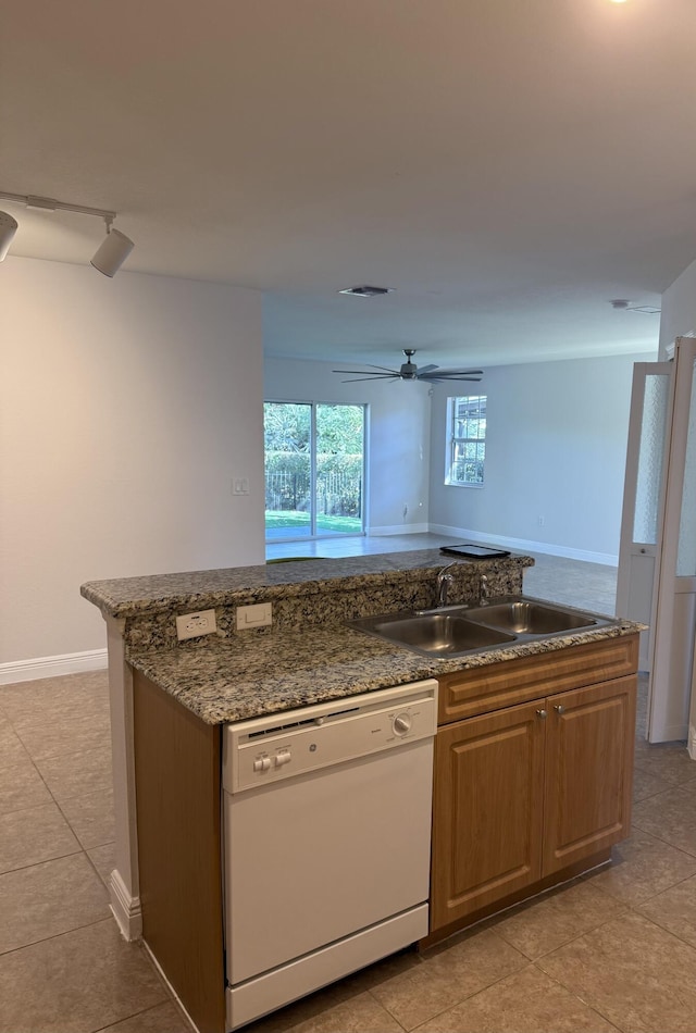 kitchen featuring white dishwasher, ceiling fan, light tile patterned floors, and sink