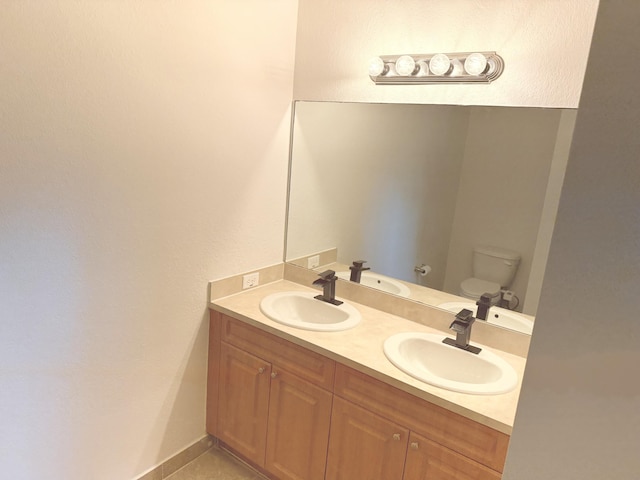 bathroom with tile patterned floors, vanity, and toilet