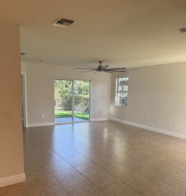 spare room featuring ceiling fan and light tile patterned floors