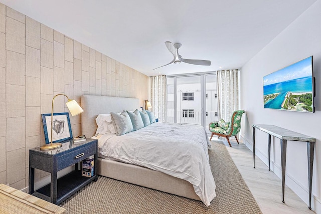 bedroom with light hardwood / wood-style floors and ceiling fan