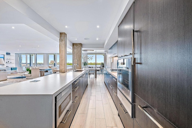 kitchen featuring a spacious island, sink, and appliances with stainless steel finishes