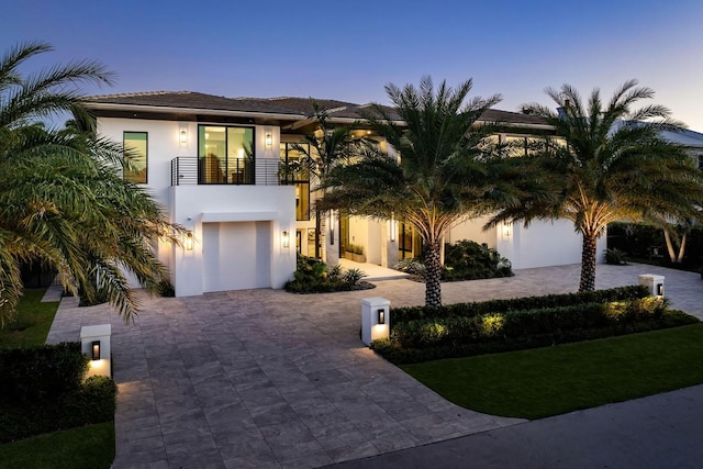 view of front of property with a balcony and a garage