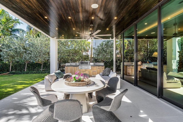 view of patio with area for grilling, ceiling fan, and grilling area