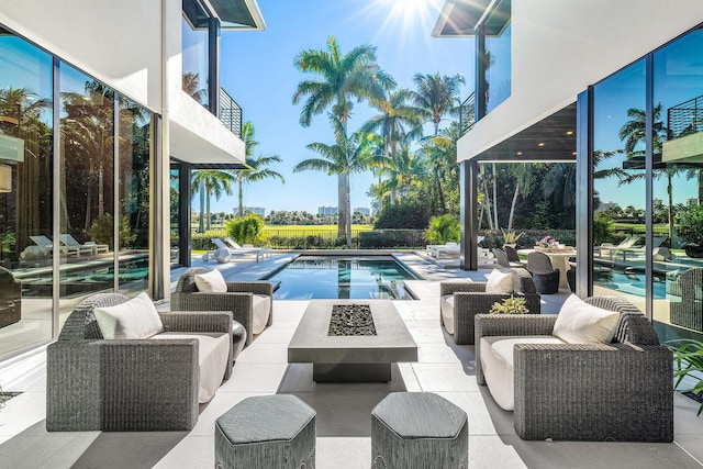 view of swimming pool with a patio area and an outdoor fire pit