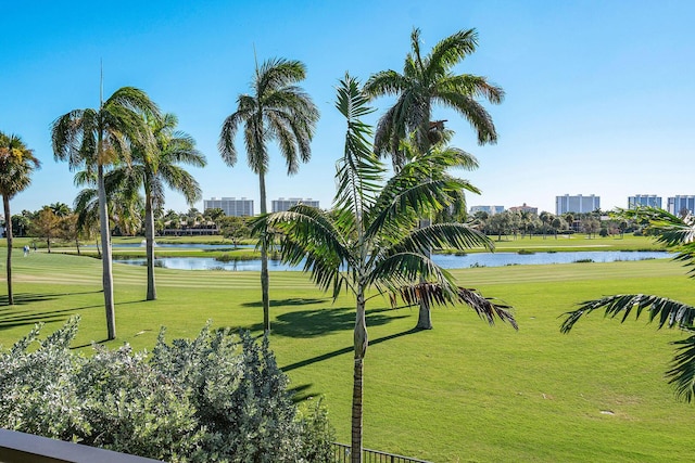 view of home's community featuring a lawn and a water view