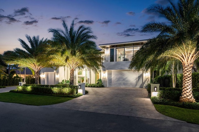 view of front of house featuring a balcony and a garage