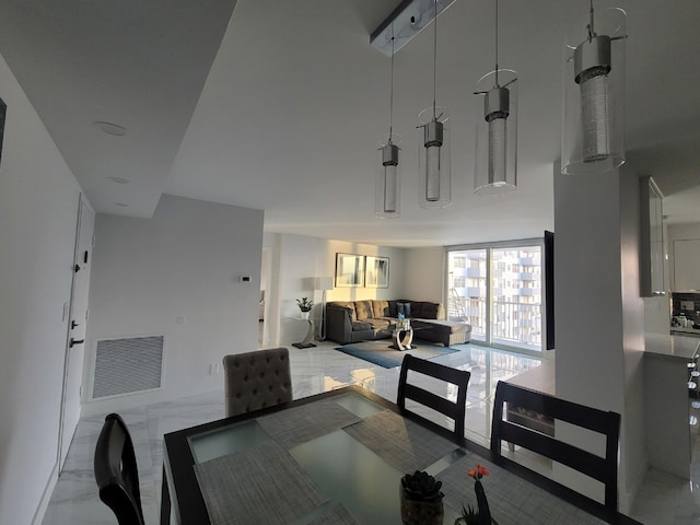 dining space featuring visible vents and marble finish floor