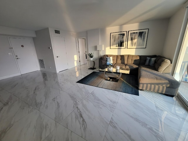 living area with visible vents and marble finish floor