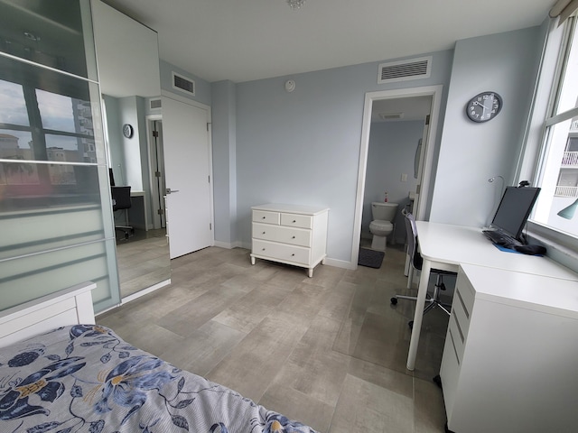 bedroom featuring light wood finished floors, visible vents, and baseboards