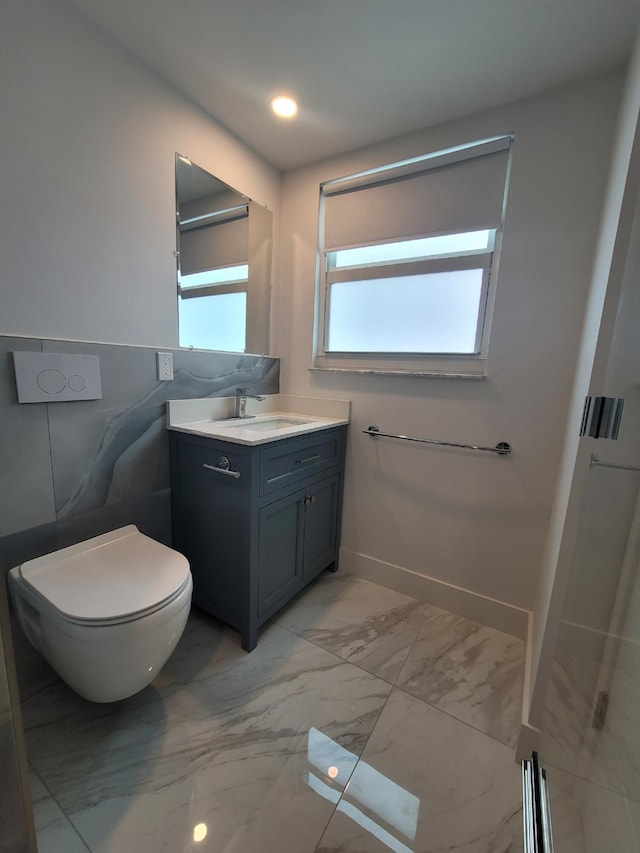 bathroom featuring baseboards, marble finish floor, vanity, and toilet