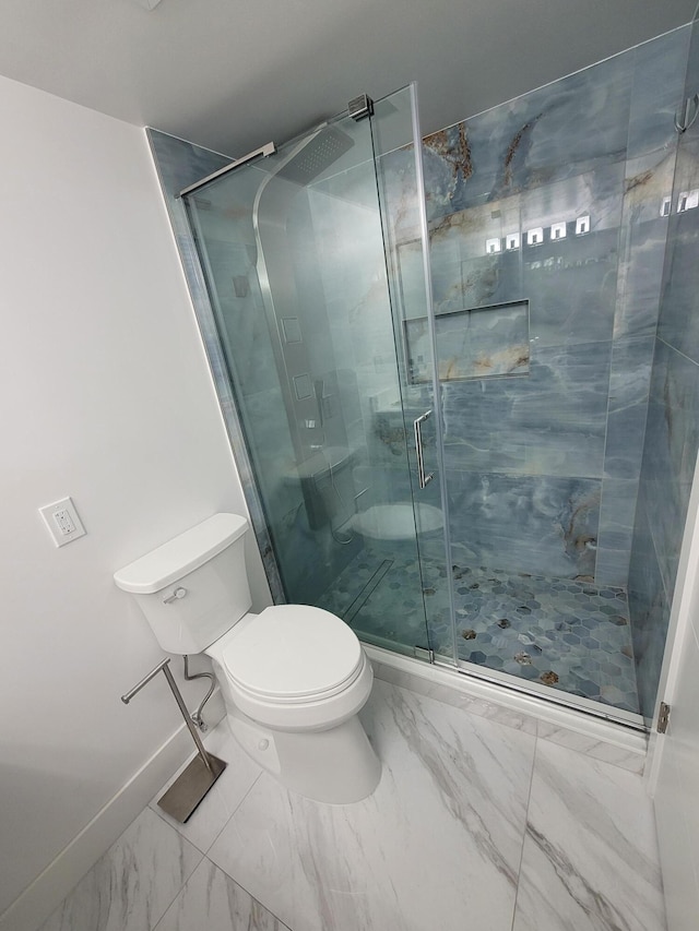 bathroom featuring a shower stall, toilet, baseboards, and marble finish floor