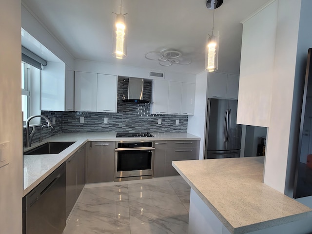 kitchen with a sink, stainless steel appliances, wall chimney exhaust hood, modern cabinets, and marble finish floor