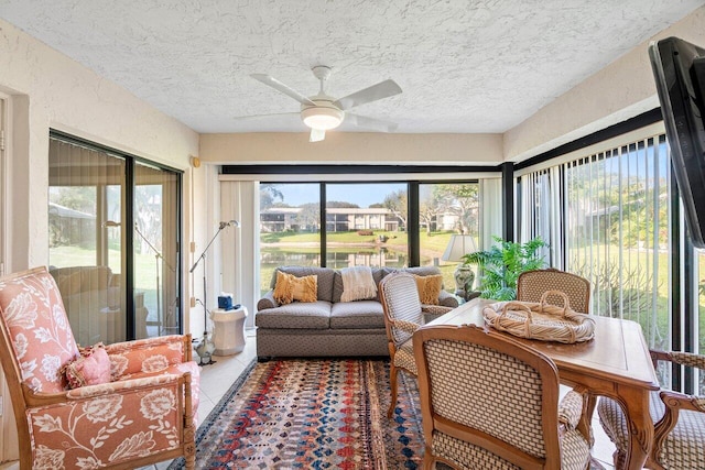 sunroom / solarium featuring plenty of natural light and ceiling fan