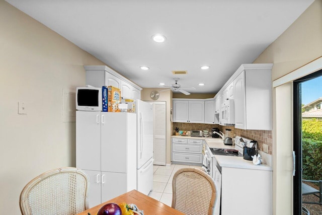 kitchen featuring tasteful backsplash, white appliances, ceiling fan, light tile patterned floors, and white cabinets