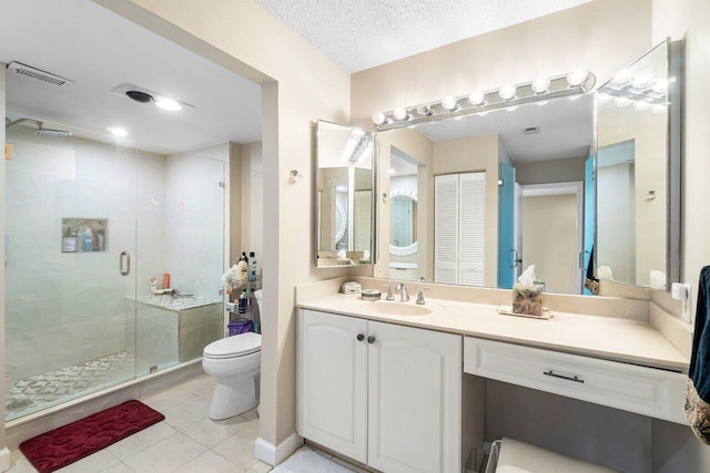 bathroom with vanity, tile patterned floors, toilet, a textured ceiling, and an enclosed shower