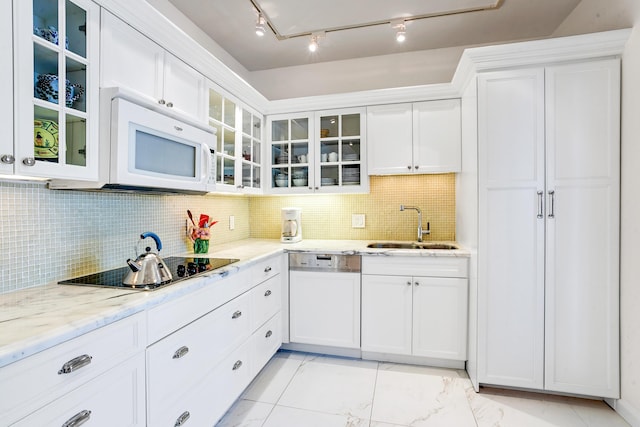 kitchen featuring light stone countertops, sink, backsplash, white appliances, and white cabinets