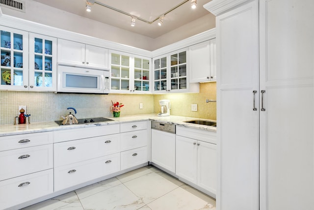 kitchen with white appliances, sink, tasteful backsplash, light stone counters, and white cabinetry