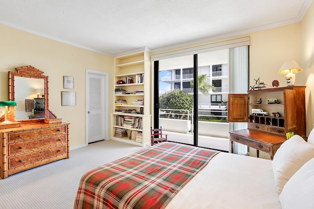 carpeted bedroom with a textured ceiling, access to exterior, and crown molding