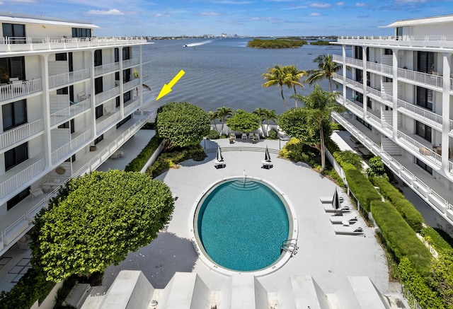 view of pool with a water view