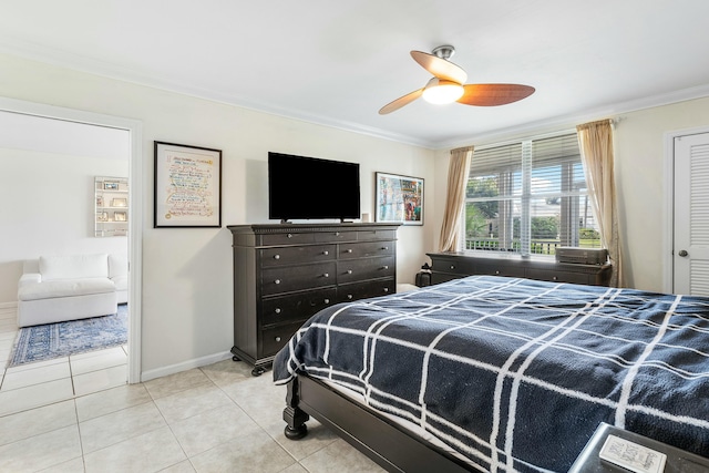 bedroom with light tile patterned floors, a closet, ceiling fan, and ornamental molding