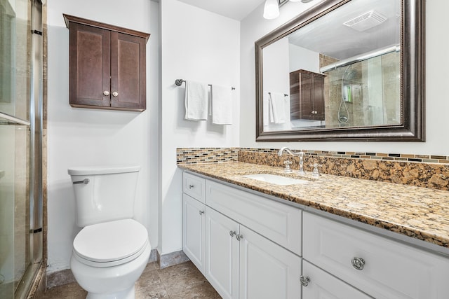 bathroom with walk in shower, vanity, and toilet