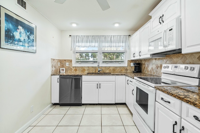 kitchen featuring white cabinetry, sink, ceiling fan, dark stone counters, and white appliances