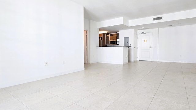 unfurnished living room featuring electric panel and light tile patterned flooring