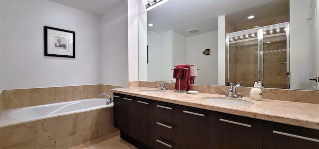 bathroom with vanity and separate shower and tub