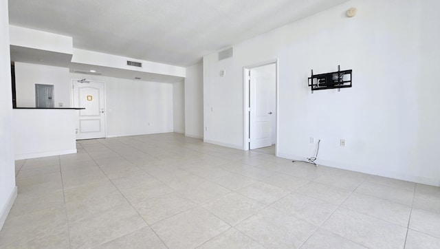 tiled empty room featuring electric panel