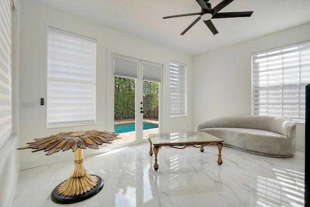 sitting room featuring ceiling fan