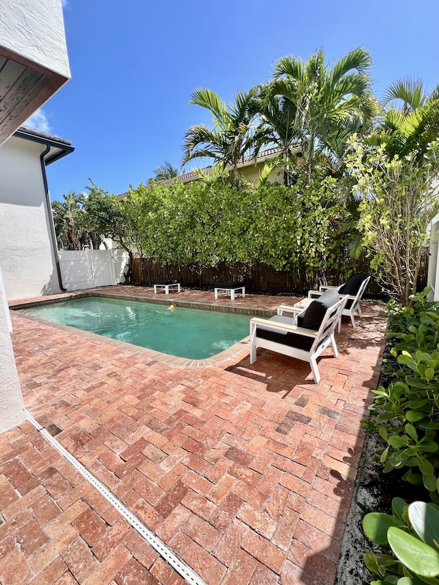 460 Surfside Ln, Juno Beach, FL 33408 - view of swimming pool featuring a patio area and a fenced backyard