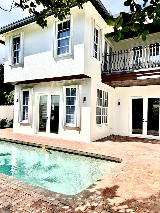 460 Surfside Ln, Juno Beach, FL 33408 - back of house featuring french doors, a balcony, stucco siding, and a patio