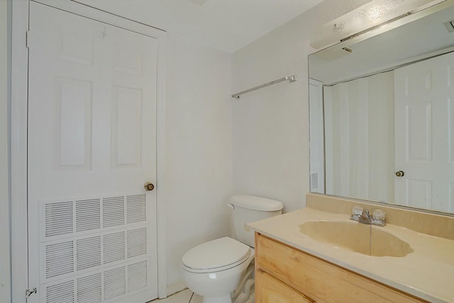 bathroom with tile patterned floors, toilet, and vanity