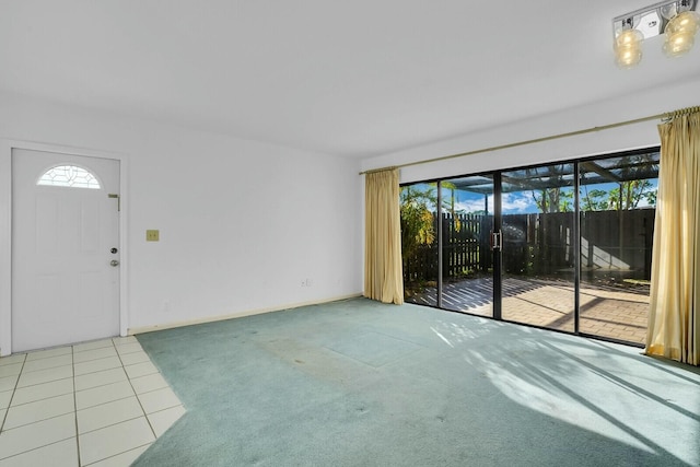 unfurnished living room with carpet and plenty of natural light