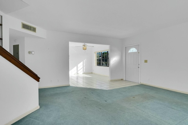 unfurnished living room featuring light carpet, ceiling fan, and electric panel