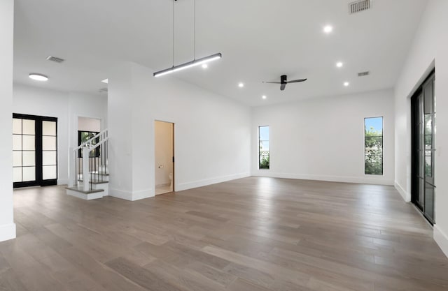 empty room with plenty of natural light and wood-type flooring