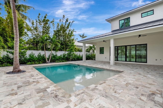 view of pool with a patio area and ceiling fan