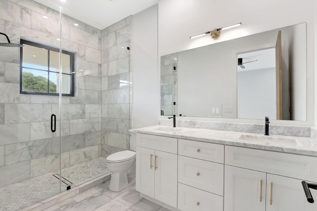 bathroom with ceiling fan, vanity, a shower with shower door, and toilet