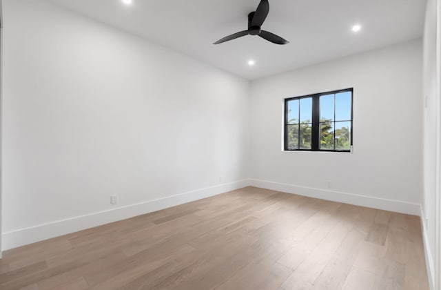 spare room featuring light hardwood / wood-style floors and ceiling fan