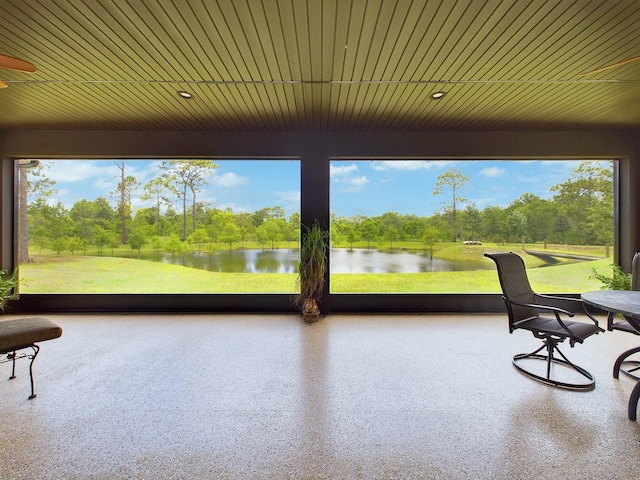 sunroom / solarium with a water view and plenty of natural light