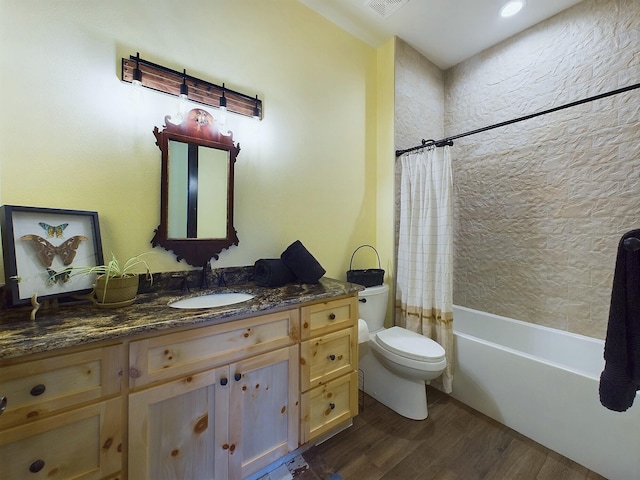 full bathroom featuring shower / tub combo, vanity, hardwood / wood-style flooring, and toilet