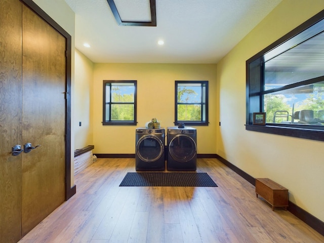 laundry area featuring light wood-type flooring and independent washer and dryer