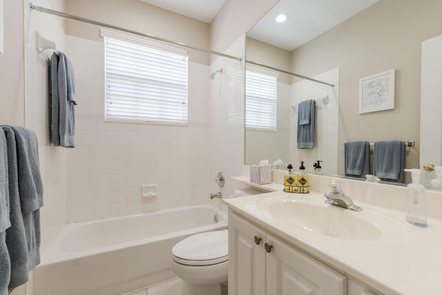 full bathroom with vanity, toilet, and tiled shower / bath combo