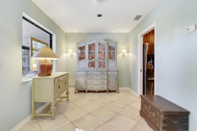 interior space with tile patterned flooring and a textured ceiling