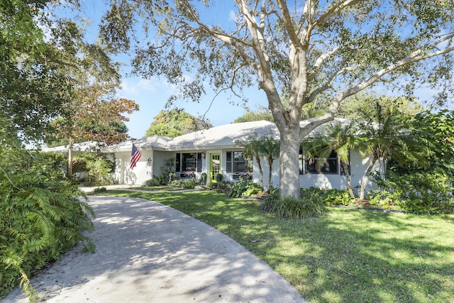 ranch-style home with a front yard