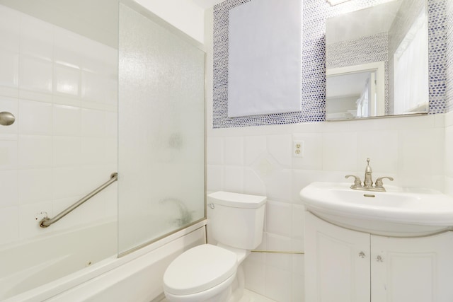 full bathroom featuring tasteful backsplash, enclosed tub / shower combo, toilet, vanity, and tile walls