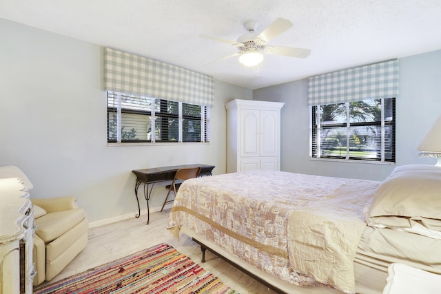 bedroom featuring ceiling fan, light hardwood / wood-style floors, and a closet