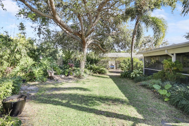 view of yard with a sunroom