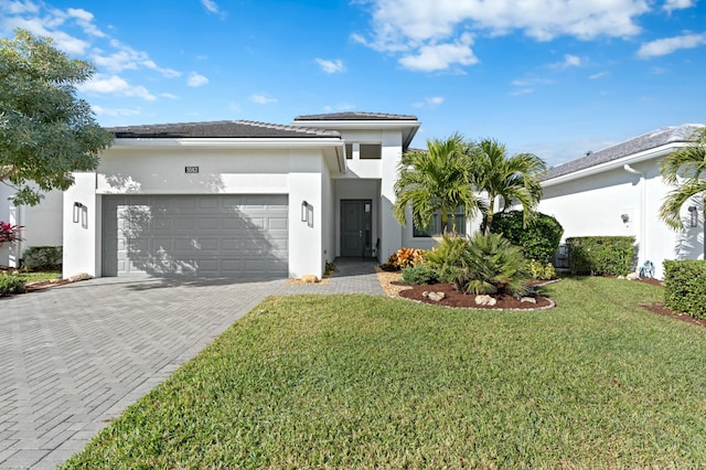 view of front of house featuring a garage and a front lawn