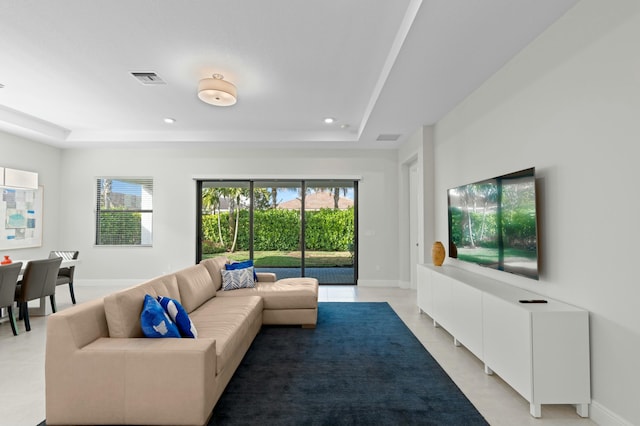 living room featuring a tray ceiling